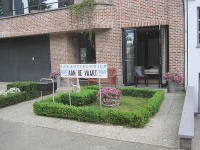 a sign in front of a brick building at aan de vaart in Mechelen