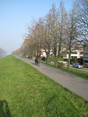 a person riding a motorcycle down a road at aan de vaart in Mechelen