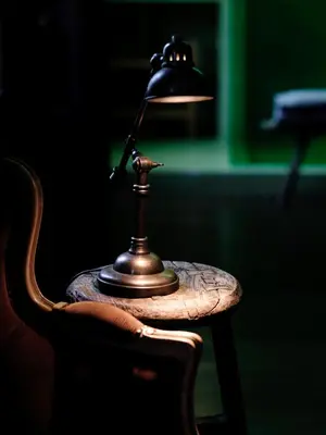 a table with a lamp on top of a chair at Verne Dreams in Ghent