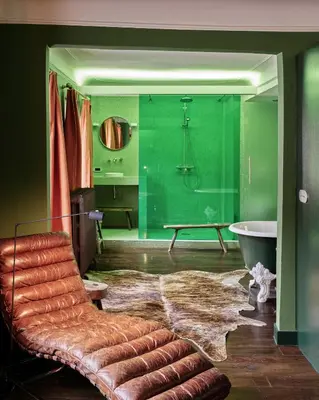 a bathroom with a couch and a bath tub and a bathroom with green at Verne Dreams in Ghent