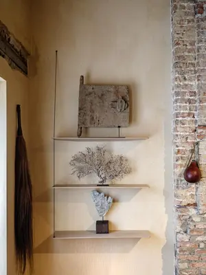 a room with white shelves on a wall with a vase at Verne Dreams in Ghent