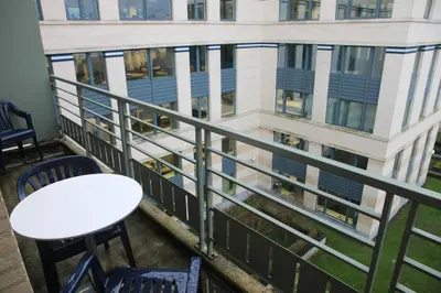 a balcony with a table and chairs and a building at NEW Design apartment in Brussels in Brussels