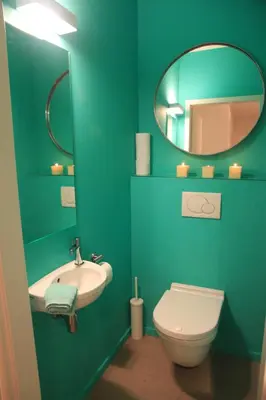 a blue bathroom with a sink and a toilet at NEW Design apartment in Brussels in Brussels