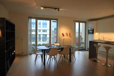 a kitchen and dining room with a table and chairs at NEW Design apartment in Brussels in Brussels