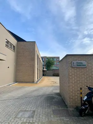 a brick building with a motorcycle parked next to it at Hobbit Hotel Mechelen in Mechelen