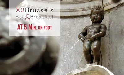 a statue of a boy drinking water from a fountain at B&B X2Brussels in Brussels