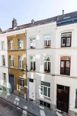 a white building with windows on a street at B&B X2Brussels in Brussels