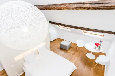 a white room with a bed and a table at B&B X2Brussels in Brussels
