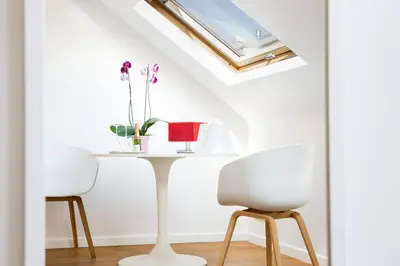 a table and two chairs in a room with a window at B&B X2Brussels in Brussels