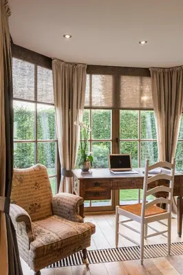 a home office with a desk and a laptop computer at Chez Maintje in Bassevelde