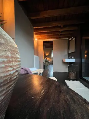 a large wooden table in a room with a living room at Guesthouse Nights by Morpheus in Antwerp