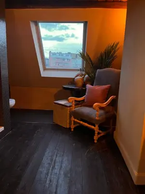 a living room with a chair and a window at Guesthouse Nights by Morpheus in Antwerp