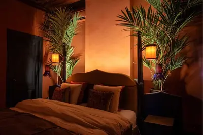 a bedroom with a bed with two plants on the wall at Guesthouse Nights by Morpheus in Antwerp