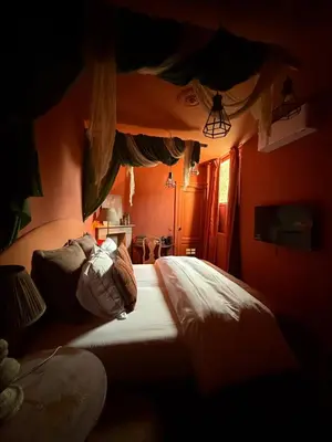 a bedroom with a bed in a red room at Guesthouse Nights by Morpheus in Antwerp