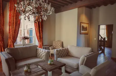 a living room with two couches and a chandelier at B&B Stillant in Gierle