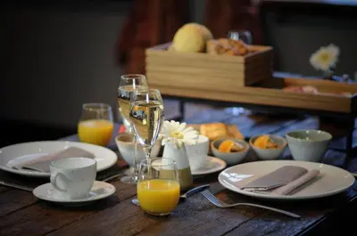 a table with glasses of champagne and plates of food at B&B Stillant in Gierle
