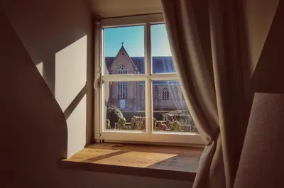 an open window with a view of a church at B&B Stillant in Gierle