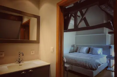 a bedroom with a bed and a sink and a mirror at B&B Stillant in Gierle