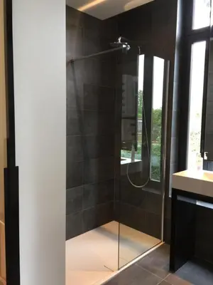 a shower with a glass door in a bathroom at Albert Molière in Brussels