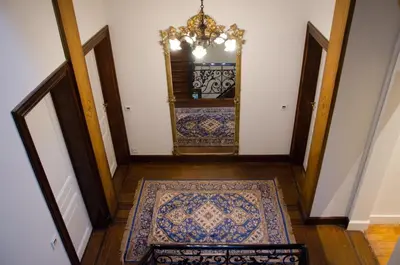 a hallway with a mirror and a rug at Albert Molière in Brussels