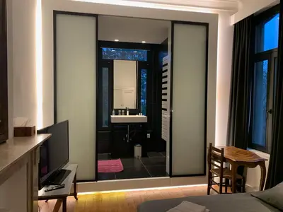 a bedroom with a view of a bathroom with a sink at Albert Molière in Brussels