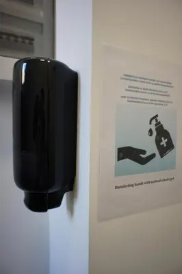 a sign on a wall next to a piece of paper at Apartments Berlaymont OHY in Brussels