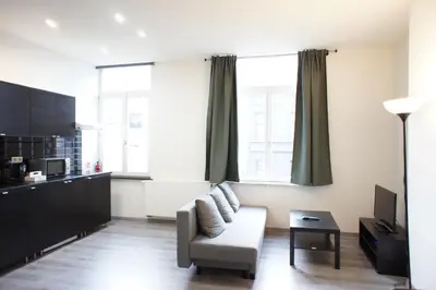 a living room with a couch and a table at Apartments Berlaymont OHY in Brussels