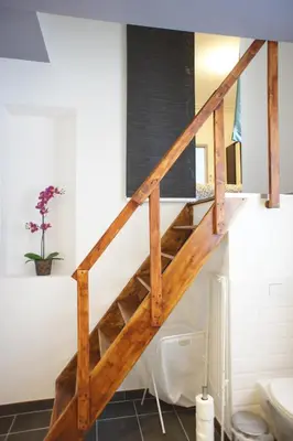 a wooden staircase in a bathroom with a toilet at Apartments Berlaymont OHY in Brussels
