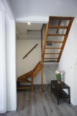 a staircase in a room with a table at Apartments Berlaymont OHY in Brussels