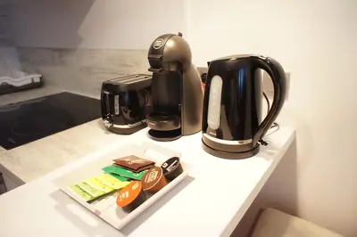 a counter with affeepot and a coffee maker on it at Apartments Berlaymont OHY in Brussels