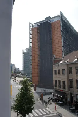 a tall building with a christmas tree in a city at Apartments Berlaymont OHY in Brussels