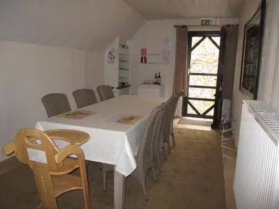 a dining room with a white table and chairs at Vakantieverblijf-Beestenboel in Retie
