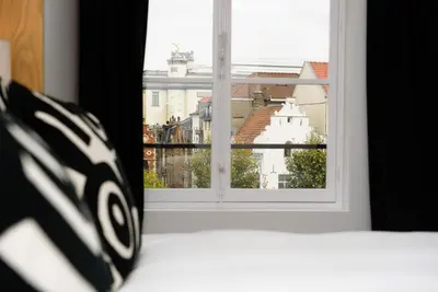 a window with a view of a city at Les Chambres de Martin in Brussels