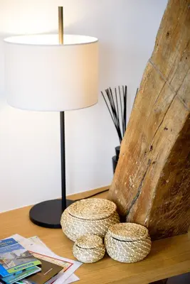 a table with a lamp and a lampost on a table at Les Chambres de Martin in Brussels