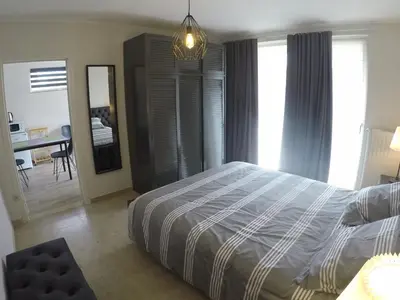 a bedroom with a bed and a desk in it at Le Lendemain in Lovendegem