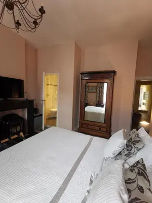 a bedroom with a large bed and a mirror at B&B La Ducale in Ghent