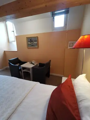 a hotel room with a bed and a table and chairs at B&B La Ducale in Ghent