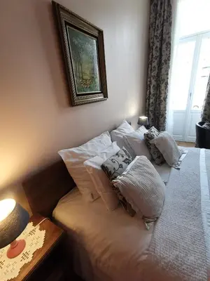 a bed with pillows on it in a bedroom at B&B La Ducale in Ghent