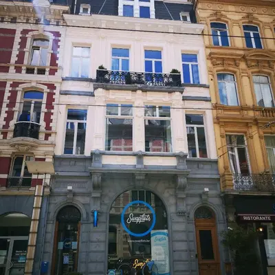 a building with a sign in front of it at B&B La Ducale in Ghent