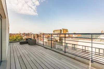 a balcony of a building with a view of the water at The Livorno in Brussels