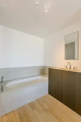 a bathroom with a tub and a sink and a mirror at The Livorno in Brussels