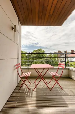 a pink table and two chairs on a balcony at The Livorno in Brussels