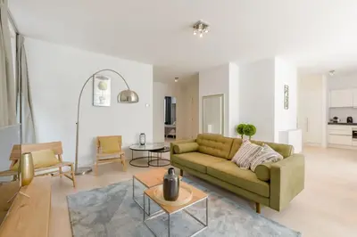 a living room with a couch and a table at The Livorno in Brussels