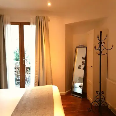 a bedroom with a bed and a mirror and a window at De Mot B&B in Brussels