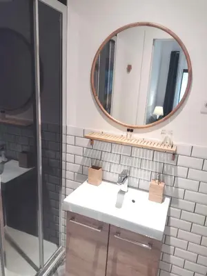 a bathroom with a sink and a mirror at De Mot B&B in Brussels