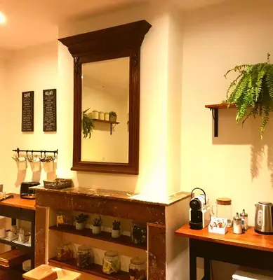 a mirror on the wall of a room with a counter at De Mot B&B in Brussels