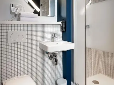 a bathroom with a sink and a toilet at ibis budget Gent Centrum Dampoort in Ghent