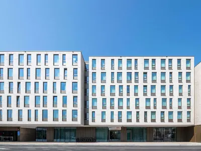 a large white building with many windows at ibis budget Gent Centrum Dampoort in Ghent