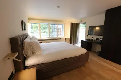 a bedroom with a large bed and a television at Hof Van Volmersele - Luxury B&B in Kampenhout