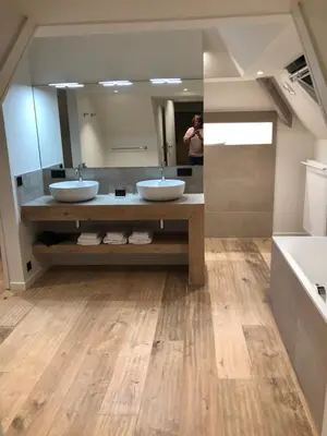 a person taking a picture of a bathroom with two sinks at Hof Van Volmersele - Luxury B&B in Kampenhout